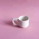 porcelanowa filizanka espresso | espresso porcelain cup | ceramika handmade inspirowana naturą | nordic inspired handmade ceramics | ręcznie robiona ceramika artystyczna | handmade ceramics inspired by the sea | ceramika inspirowana nordyckim wybrzeżem | nordic coastal ceramics | ceramika inspirowana oceanem | ceramics inspired by northern landscapes | unikatowa ceramika handmade | slow design handmade ceramics | ceramika z naturalną fakturą | textured handmade ceramics | ceramika użytkowa handmade | functional handmade ceramics | ceramika inspirowana lofotami | nordic sea inspired ceramics | nowa kolekcja ceramiki handmade | artisanal ceramic collection | ceramika z duszą | ceramics made slowly by hand | pantone cloud dancer | vogue living